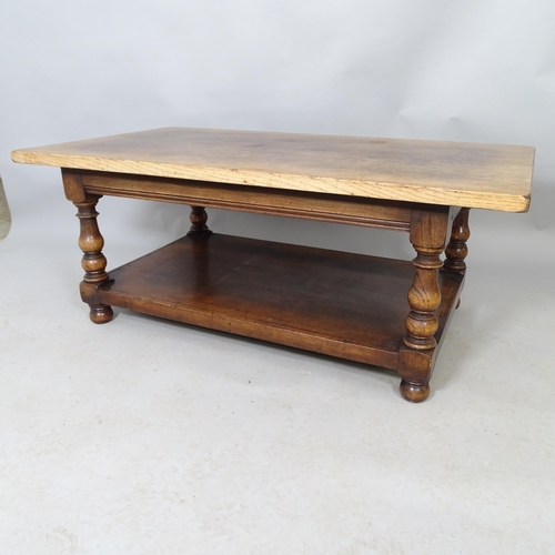 2563 - An oak two-tier coffee table. 122cm x 49cm x 69cm