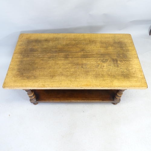 2563 - An oak two-tier coffee table. 122cm x 49cm x 69cm