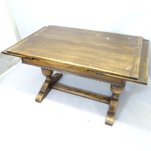 2564 - An early 20th century oak refectory draw-leaf dining table raised on baluster turned legs with H-sha... 