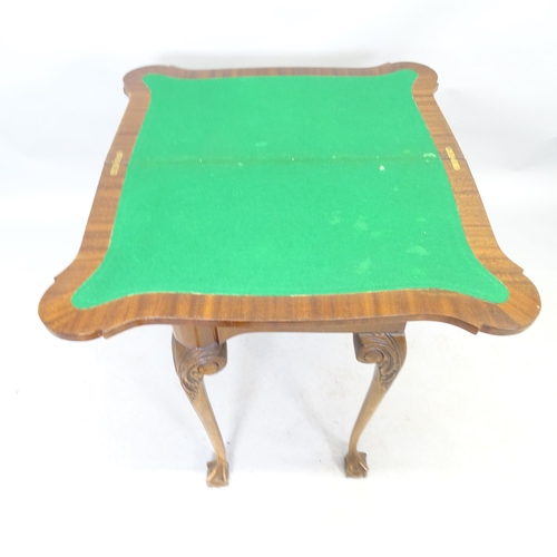 2571 - A reproduction oak fold-over card table raised on cabriole legs, with claw and ball feet. 76cm x 75c... 