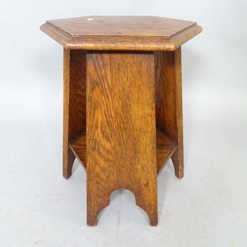 2572 - An Arts and Crafts oak two-tier hexagonal occasional table. 30cm x 46cm