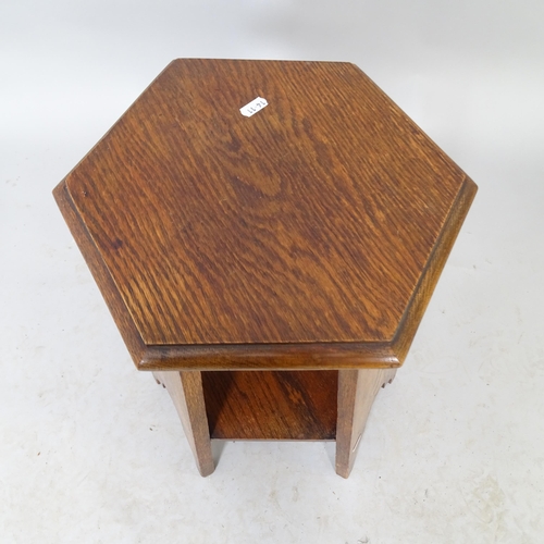 2572 - An Arts and Crafts oak two-tier hexagonal occasional table. 30cm x 46cm