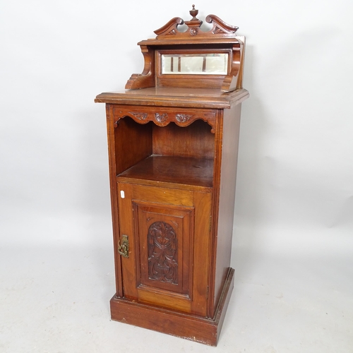 2577 - An early 20th century mahogany music cabinet with raised mirror back and single carved door. 42cm x ... 