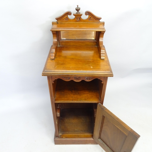 2577 - An early 20th century mahogany music cabinet with raised mirror back and single carved door. 42cm x ... 