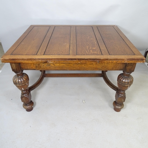 2583 - An antique oak draw-leaf dining table, raised on baluster turned legs with H-shaped stretcher. 130cm... 