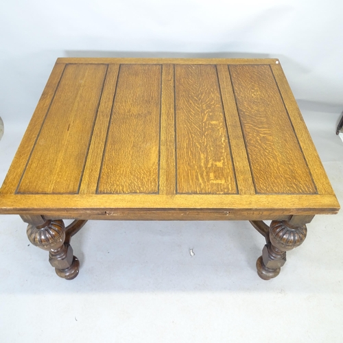 2583 - An antique oak draw-leaf dining table, raised on baluster turned legs with H-shaped stretcher. 130cm... 