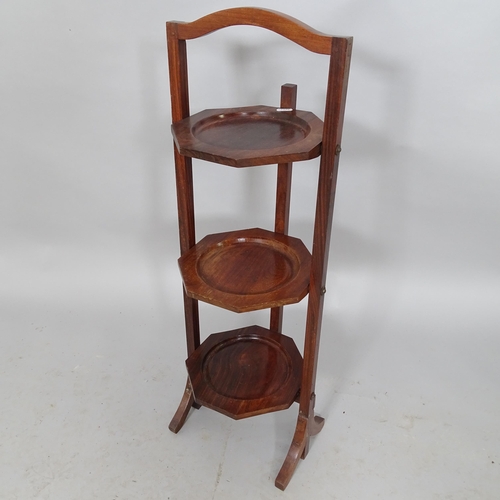 2598 - A mahogany three tier folding cake stand, height 80cm