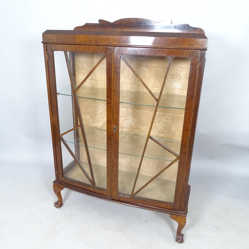 2609 - A 1930s mahogany display cabinet with raised back, two glazed and panelled doors, two fixed shelves ... 