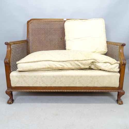 2614 - A 1920s Bergere three piece suite comprising a two-seater settee, 118cm x 90cm x 84cm, and two match... 