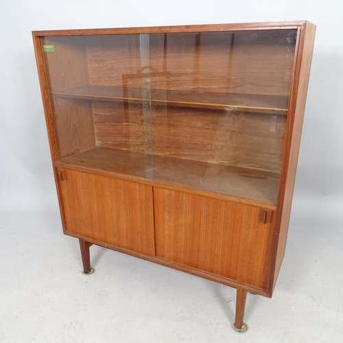 2620 - A mid-century teak display cabinet with glass sliding doors, cupboards under and label for Beaver an... 