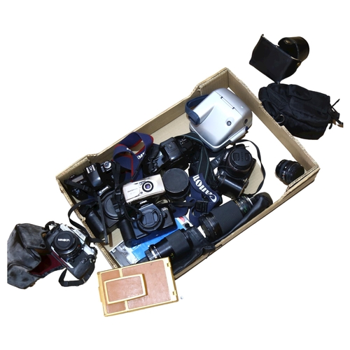 233 - A quantity of various Vintage cameras and accessories, including Canon, Minolta, Polaroid etc