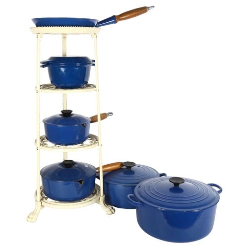 246 - A set of blue Le Creuset pans, and accompanying stand, set includes 2 large cooking pots, a frying p... 