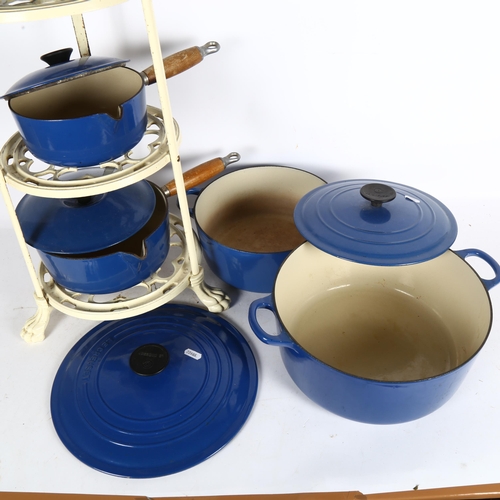 246 - A set of blue Le Creuset pans, and accompanying stand, set includes 2 large cooking pots, a frying p... 