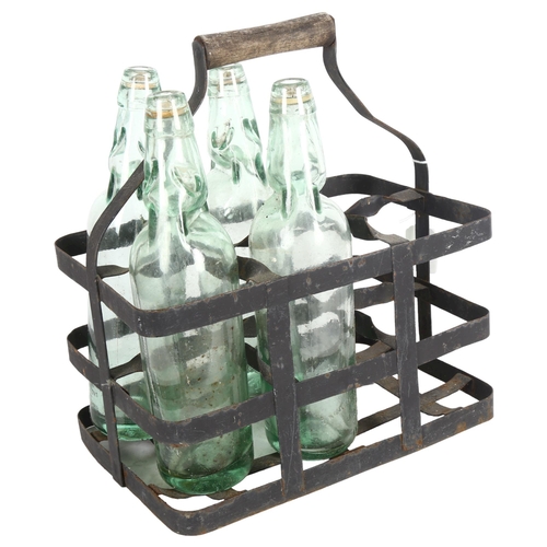 267 - A Vintage bottle carrier with 4 codd-neck bottles with glass marbles, all bottles marked with maker'... 