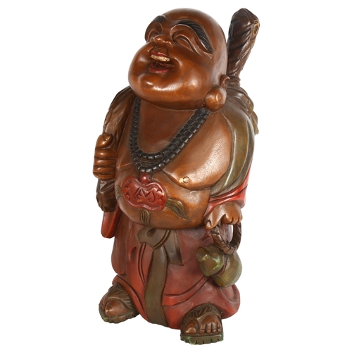 289 - A carved and stained wood smiling Buddha, height 62cm