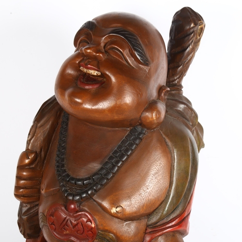 289 - A carved and stained wood smiling Buddha, height 62cm