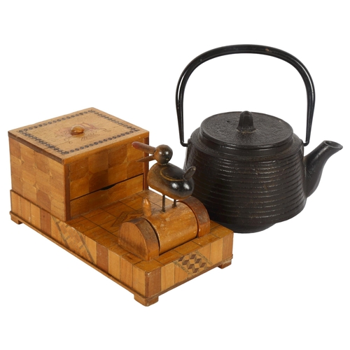 304 - An early signed Japanese iron tea ceremonial teapot, plus a circa 1930s articulated wooden cigarette... 