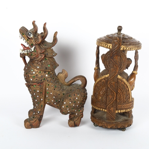 310 - A carved wood figure of Ganesha and a carved wood figure of a foo dog, largest 29cm (2)