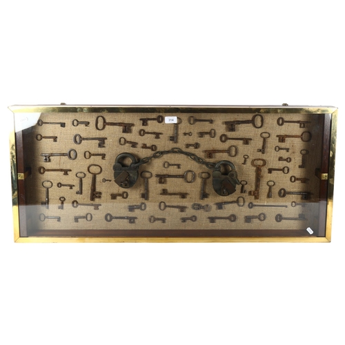 314 - A large wall-hanging display case containing Vintage and Antique skeleton keys, including a set of V... 