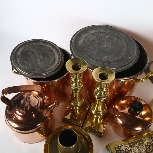 317 - A quantity of brass and copper kitchen utensils, including various boiling pots, teapots, a teapot s... 