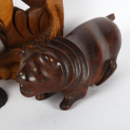 320 - An ebony carved wood Indian elephant, with plastic tusks and eyes, a hardwood carving of a lion, and... 