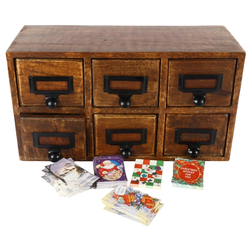 322 - An apothecary or desk-top 6-drawer filing cabinet, each drawer contains various Christmas labels, le... 