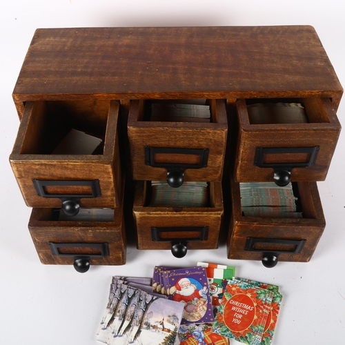 322 - An apothecary or desk-top 6-drawer filing cabinet, each drawer contains various Christmas labels, le... 