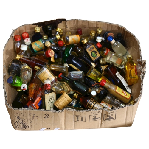 343 - A large quantity of alcoholic miniatures, including Ouzo, Brandy, Rum, Tequila etc