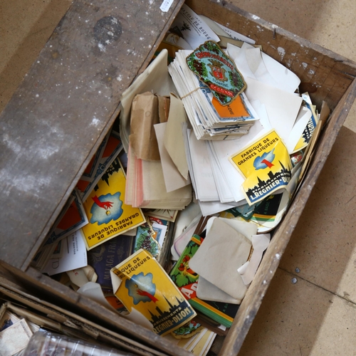 357 - A large quantity of wine labels in a pine crate