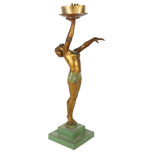 406 - An Art Deco gilded spelter figure holding a globular glass light shade on stepped plinth, height 62c... 