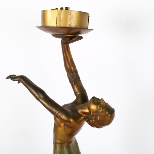 406 - An Art Deco gilded spelter figure holding a globular glass light shade on stepped plinth, height 62c... 