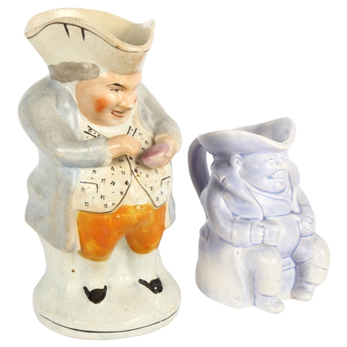 442 - An Antique pottery Toby taking snuff, and a smaller Toby jug