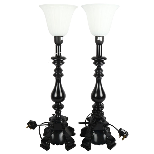 468 - A pair of black composition table lamps with white glass shades, height 62cm