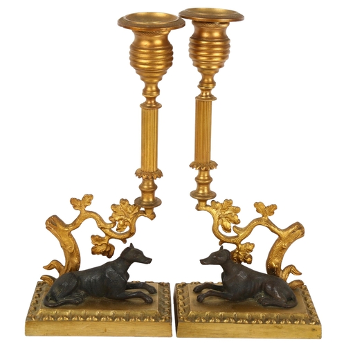 492 - A pair of gilt-bronze candlesticks with hound figures, height 25cm