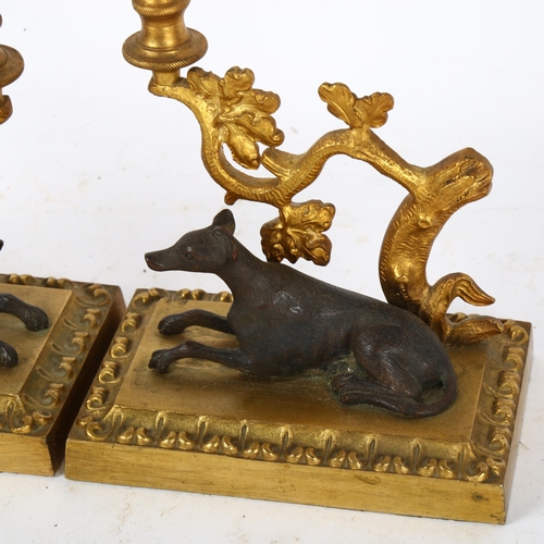 492 - A pair of gilt-bronze candlesticks with hound figures, height 25cm