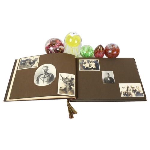 495 - A Vintage family photograph album, and 5 glass paperweights