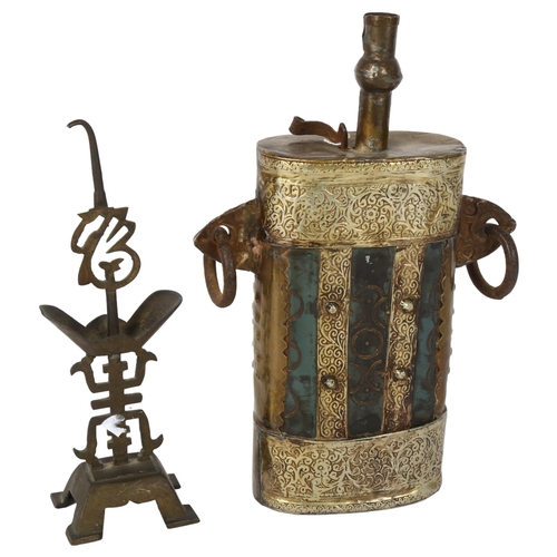 508 - An Eastern lamp with ring handles and embossed decoration, 23cm, and another