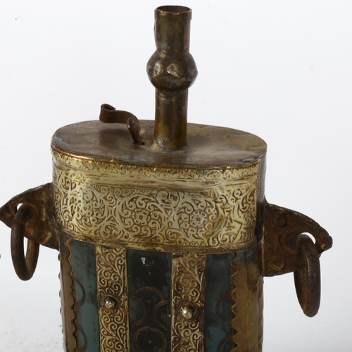 508 - An Eastern lamp with ring handles and embossed decoration, 23cm, and another