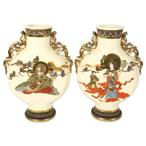 530 - A pair of Japanese cream ground moon flasks, with gilded dragon handles, height 32cm