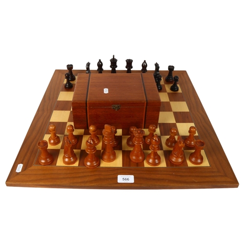 566 - A modern turned wood chess set, complete with 32 pieces and chess board, King height 11cm