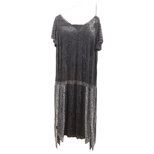 608 - A 1920s style black flapper dress, with intricate beading decoration, no size label