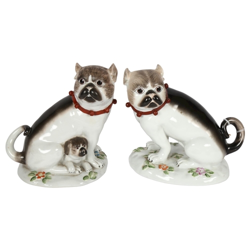 612 - A pair of German ceramic Pugs, on floral decorated bases, height 19cm