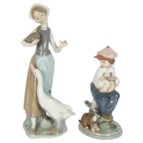 613 - A Lladro boy with puppy, and a Lladro girl with duck, height 23cm