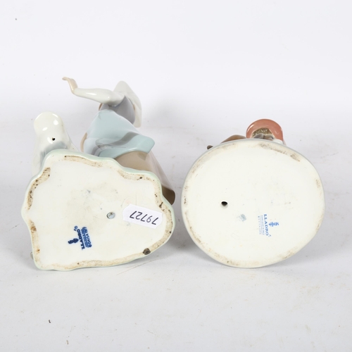 613 - A Lladro boy with puppy, and a Lladro girl with duck, height 23cm