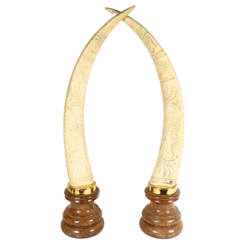 645 - A pair of composition Scrimshaw style ornamental horns on plinths, height 76cm