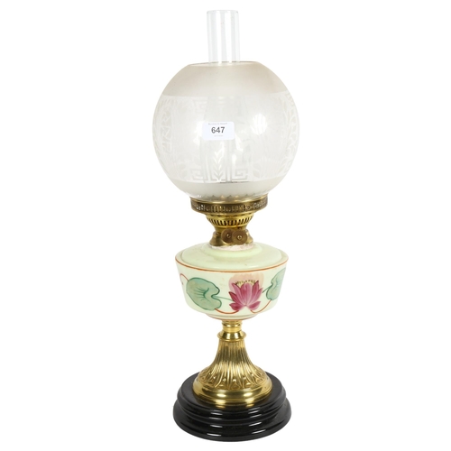 647 - A Victorian and brass oil lamp, with etched clear glass shade and milk glass painted font, on a terr... 