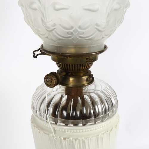 650 - A Royal Worcester ivory porcelain oil lamp, model no. 1576, with Hinks's duplex no. 2 burner, with c... 