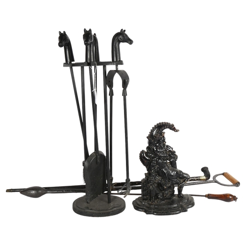 658 - A fire companion set with horse head finials, a walking stick, Mr Punch doorstop etc