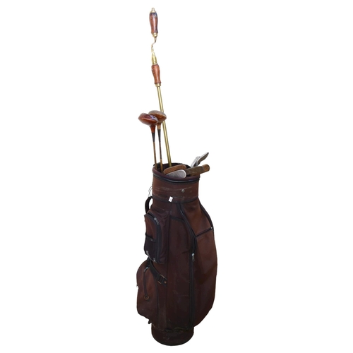 661 - Wooden shafted golf clubs in bag, and a brass and turned wood window winder