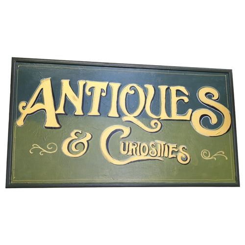 664 - A painted and gilded wood sign 